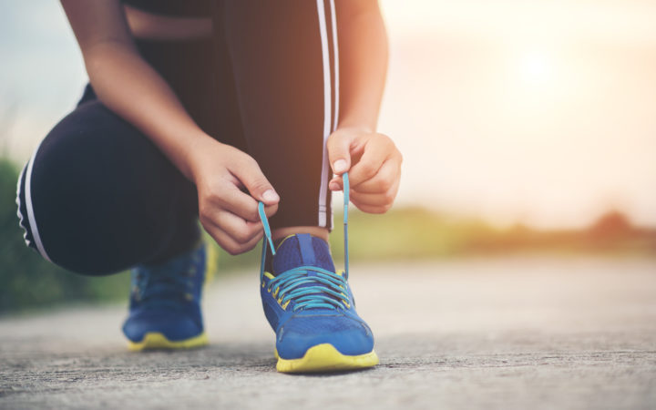 Close Up Shoes Female Runner Tying Her Shoes For A Jogging Exerc