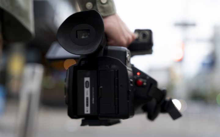 Man Holding His News Camera